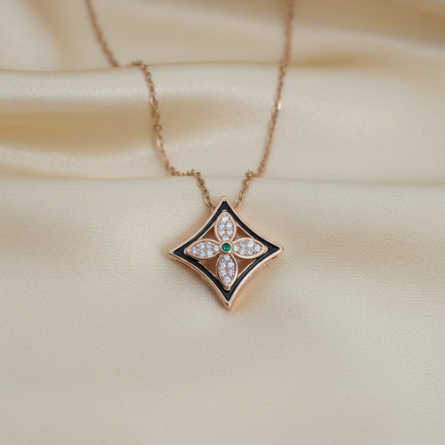 Star-shaped pendant necklace on a light blue background