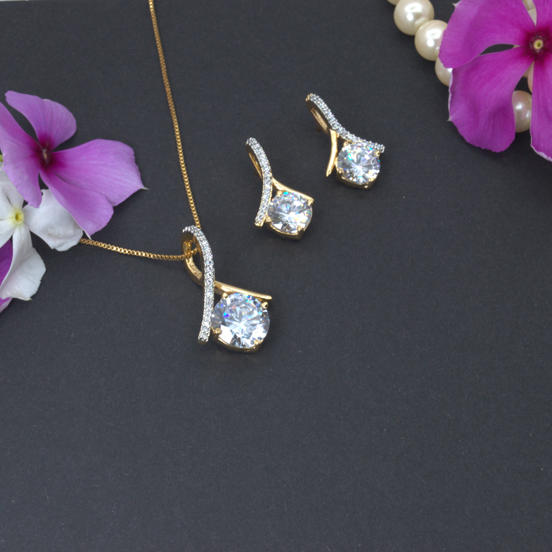 Jewelry set with necklace and earrings on a dark surface with flowers.
